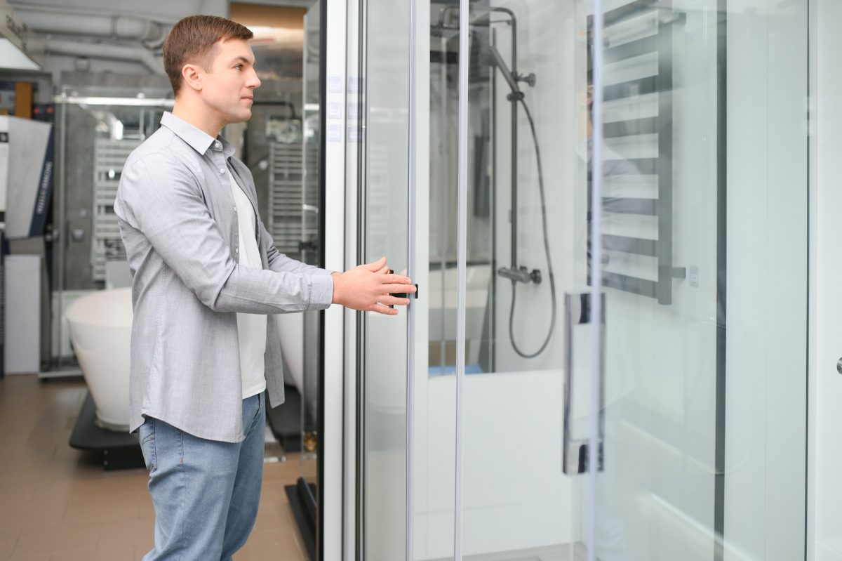 Man choosing shower at the building market
