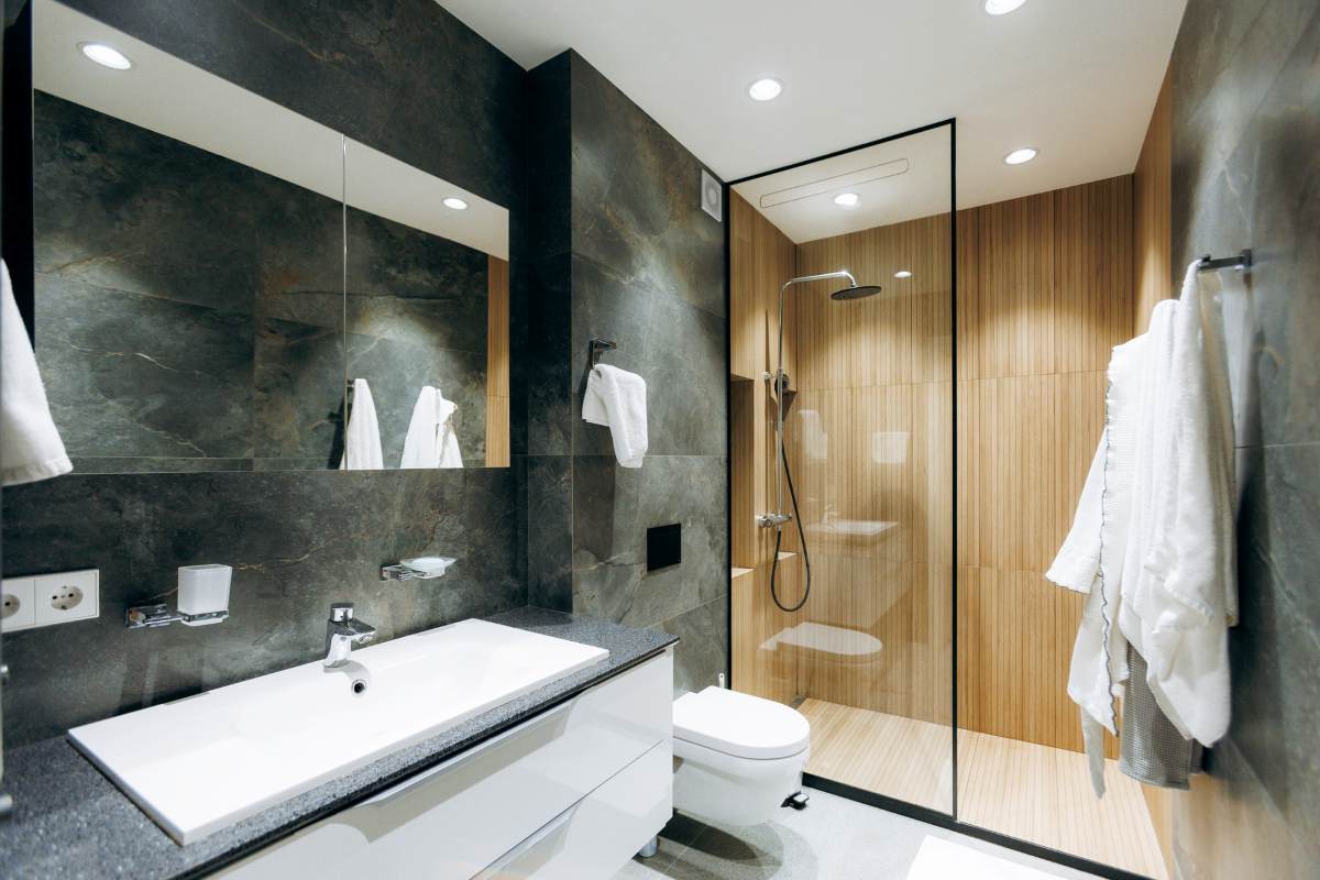 Sophisticated restroom featuring premium fixtures and plush robes